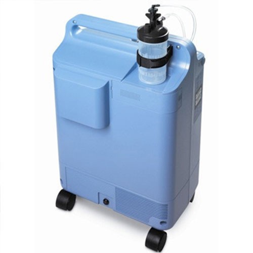 Philips EverFlo oxygen concentrator — rear view with the humidifier bottle fitted to the side bracket