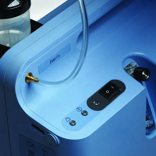 Close-up of the Philips EverFlo control panel — power switch, indicator lights and oxygen outlet connector